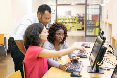 instructor-helping-students-computer-class_74855-2020